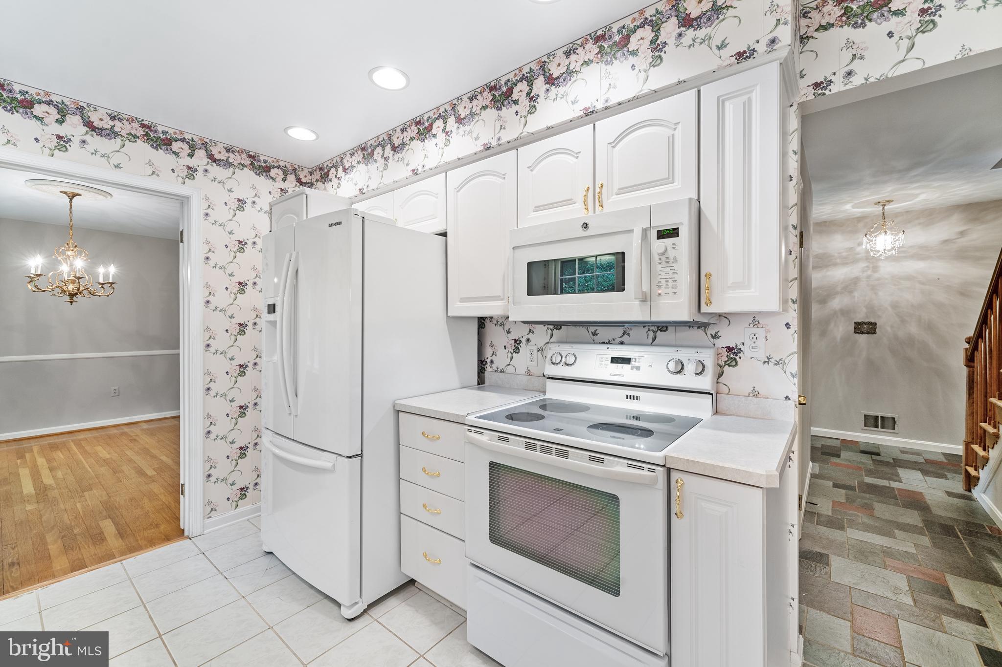 1643 Homewood Road Annapolis, MD 21409 - Photo 23 of 59 a kitchen with white cabinets and appliances