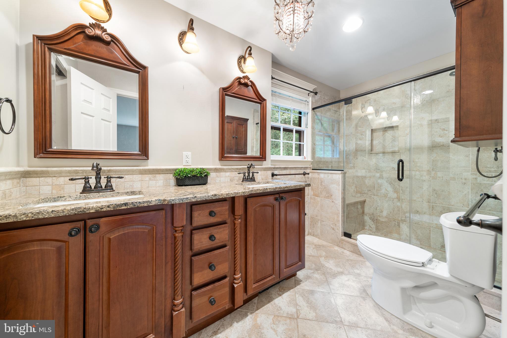 1643 Homewood Road Annapolis, MD 21409 - Photo 38 of 59 a spacious bathroom with a granite countertop sink mirror toilet and bathtub