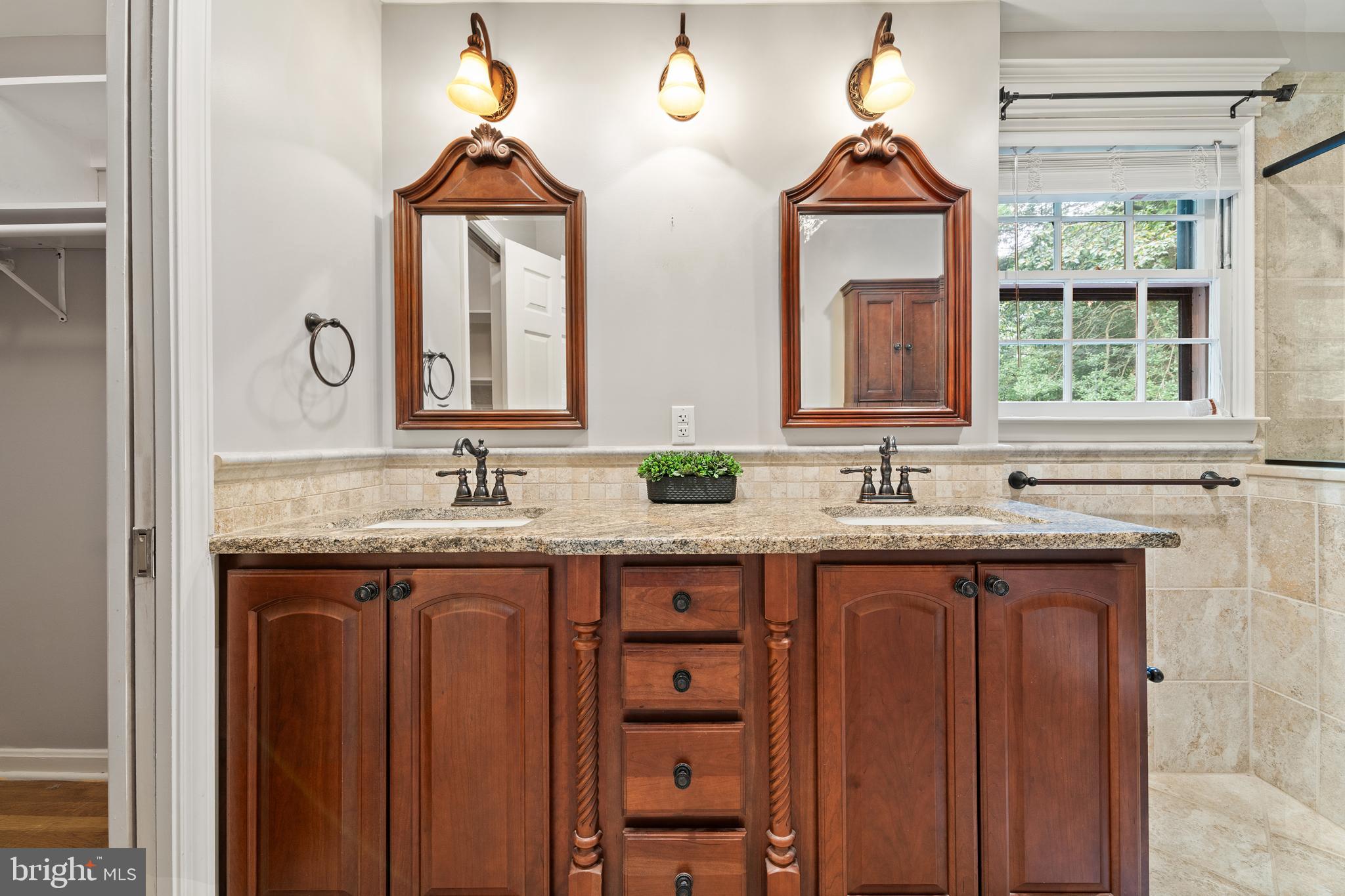 1643 Homewood Road Annapolis, MD 21409 - Photo 40 of 59 a bathroom with a granite countertop sink and a large mirror