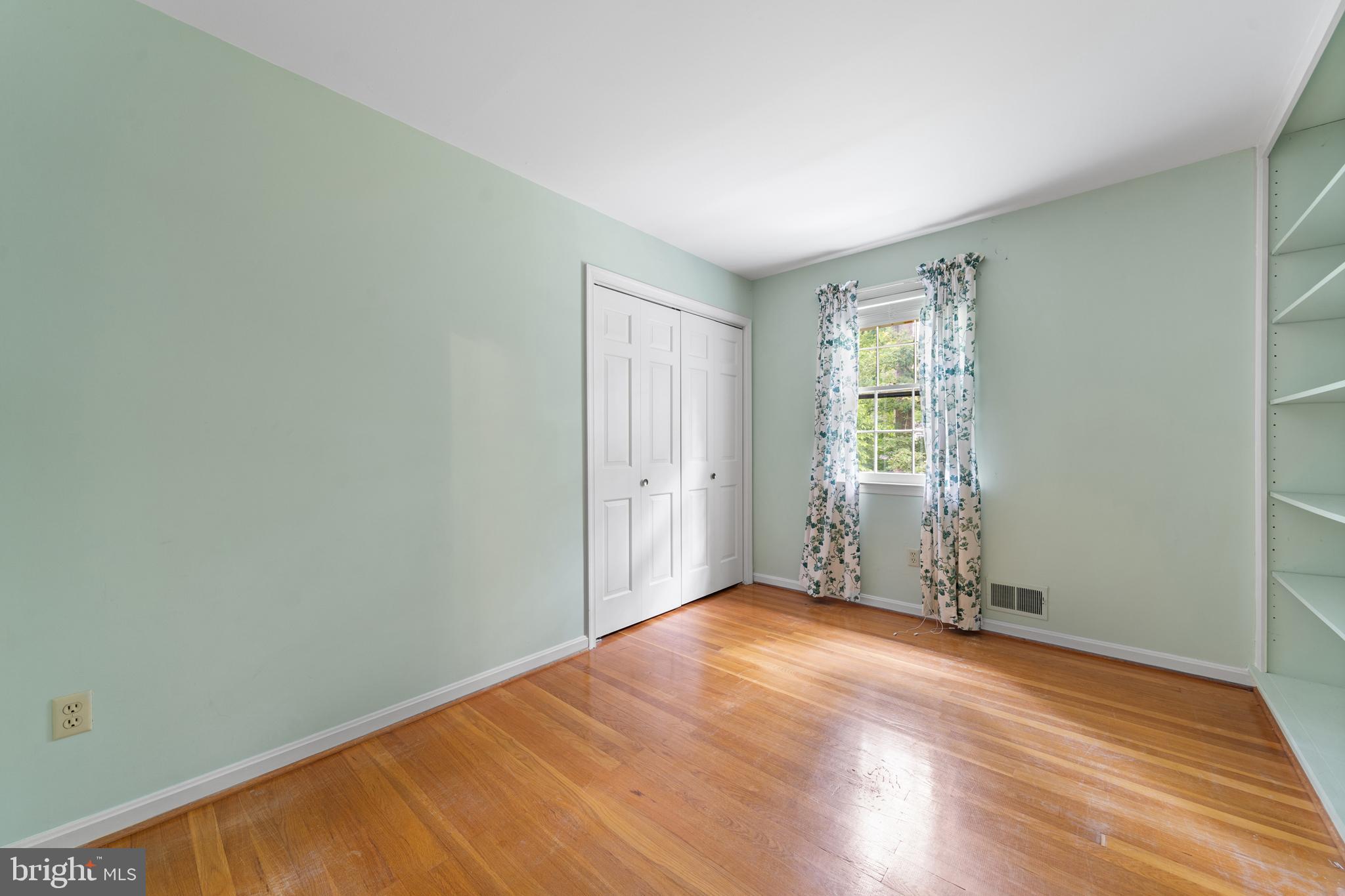 1643 Homewood Road Annapolis, MD 21409 - Photo 42 of 59 an empty room with wooden floor and windows