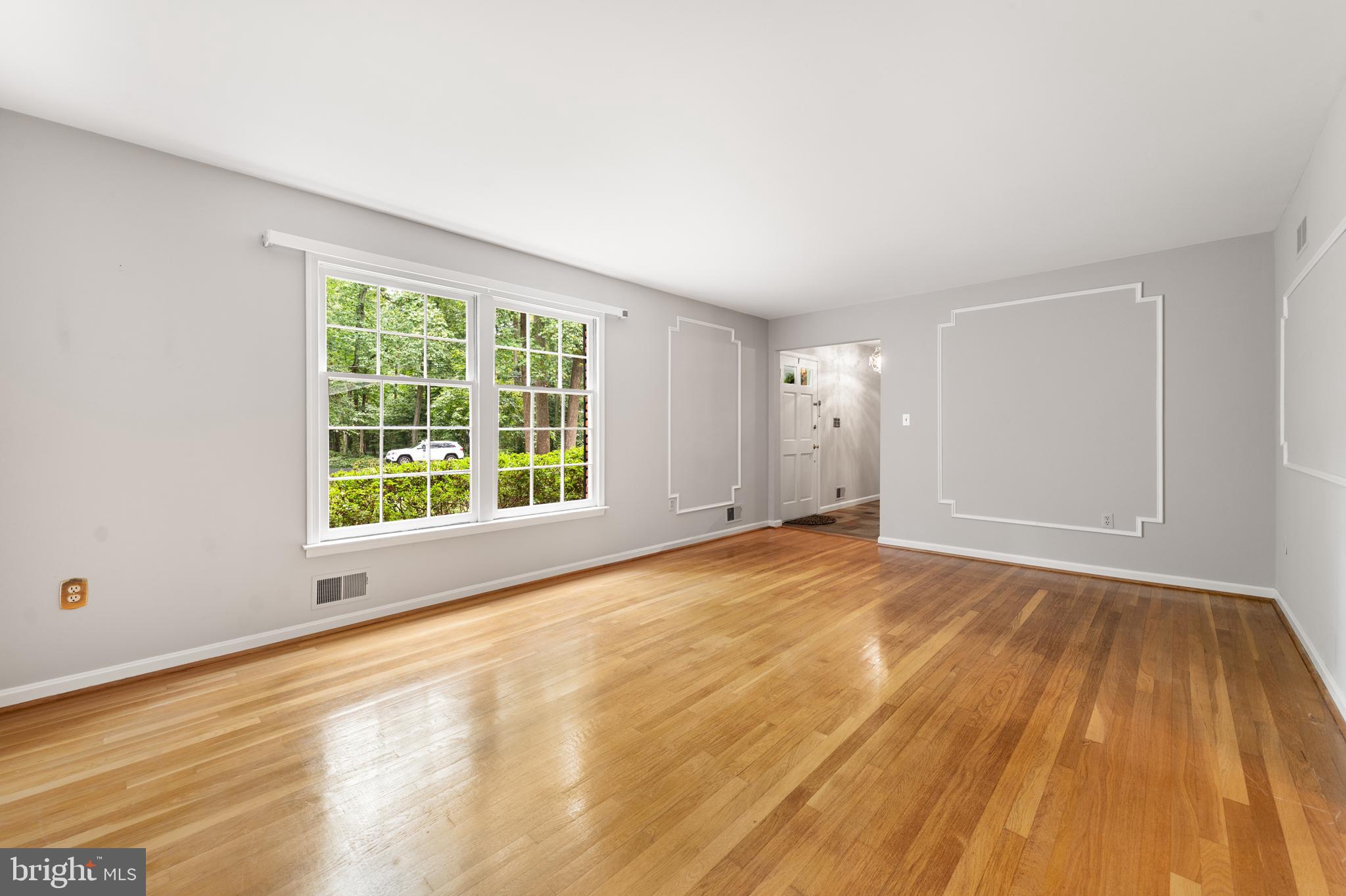 1643 Homewood Road Annapolis, MD 21409 - Photo 43 of 59 a view of an empty room with wooden floor and a window