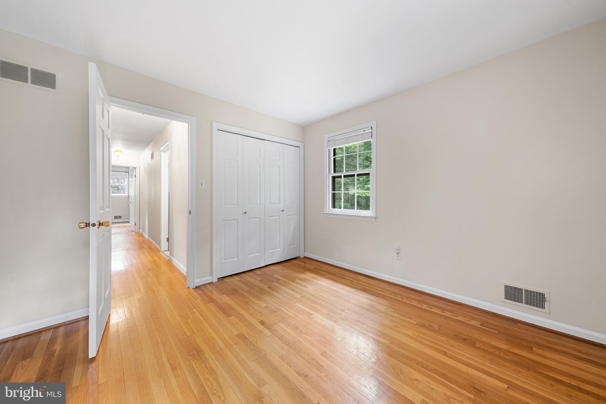1643 Homewood Road Annapolis, MD 21409 - Photo 47 of 59 a view of an empty room with wooden floor and a window