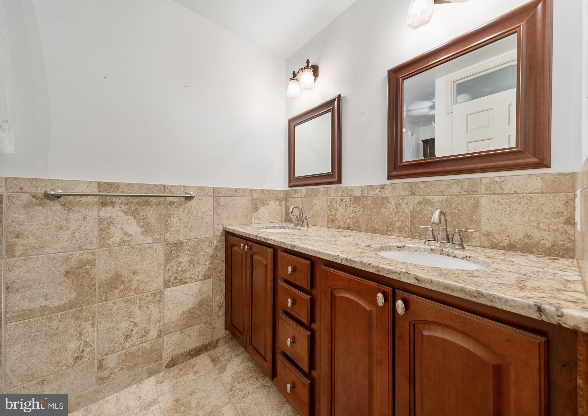 1643 Homewood Road Annapolis, MD 21409 - Photo 50 of 59 a bathroom with a granite countertop sink and a mirror
