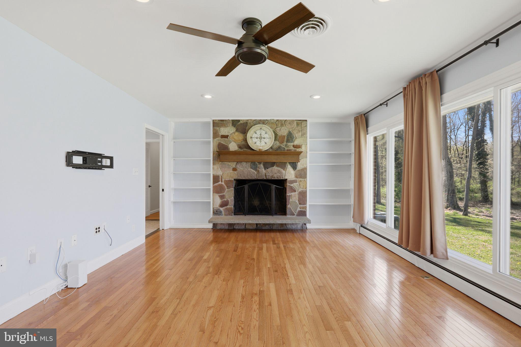 35 Oriole Way Moorestown, NJ 08057 - Photo 11 of 45 a view of an empty room with a fireplace and a window