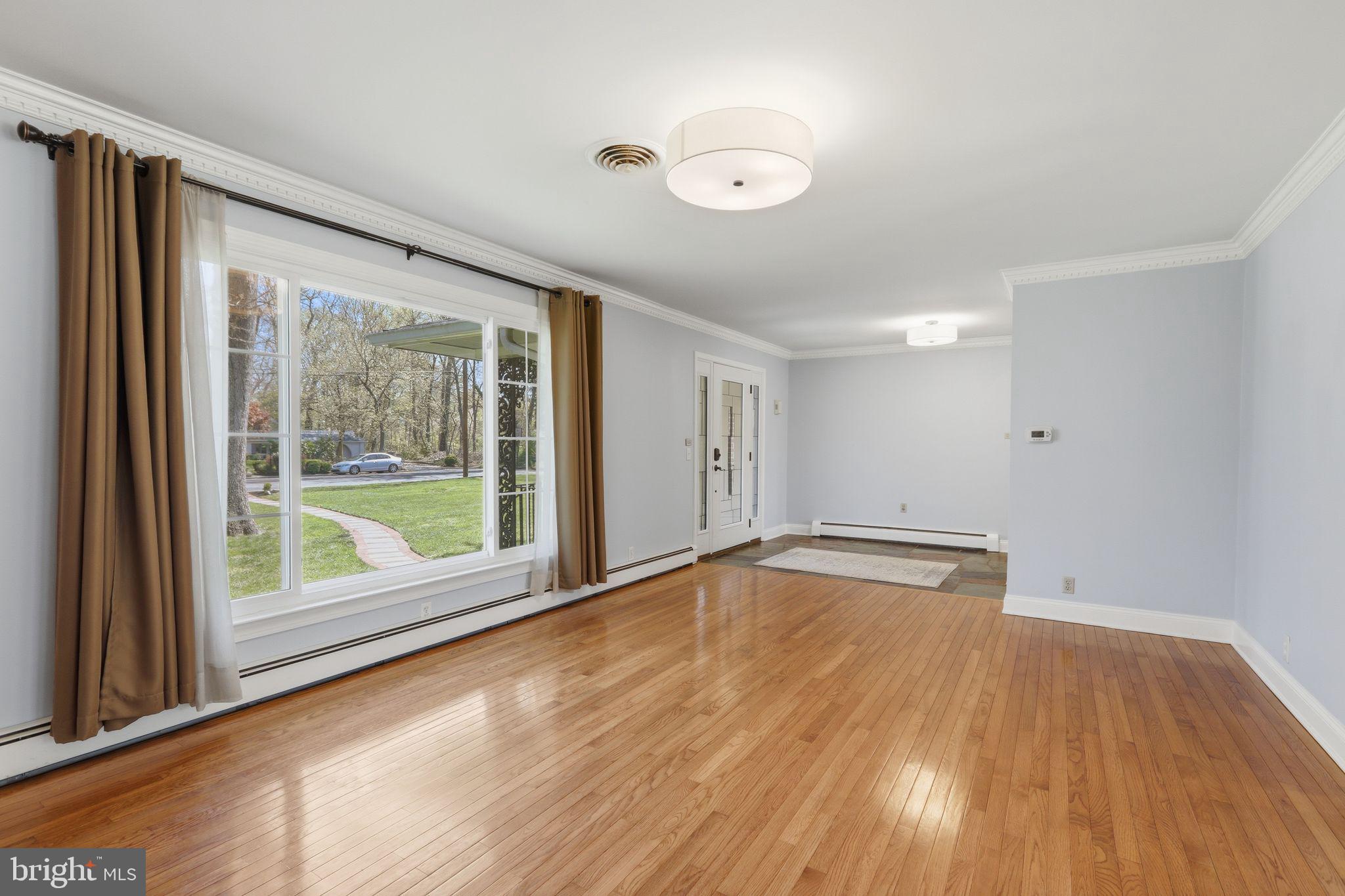 35 Oriole Way Moorestown, NJ 08057 - Photo 4 of 45 a view of an empty room with wooden floor and a window