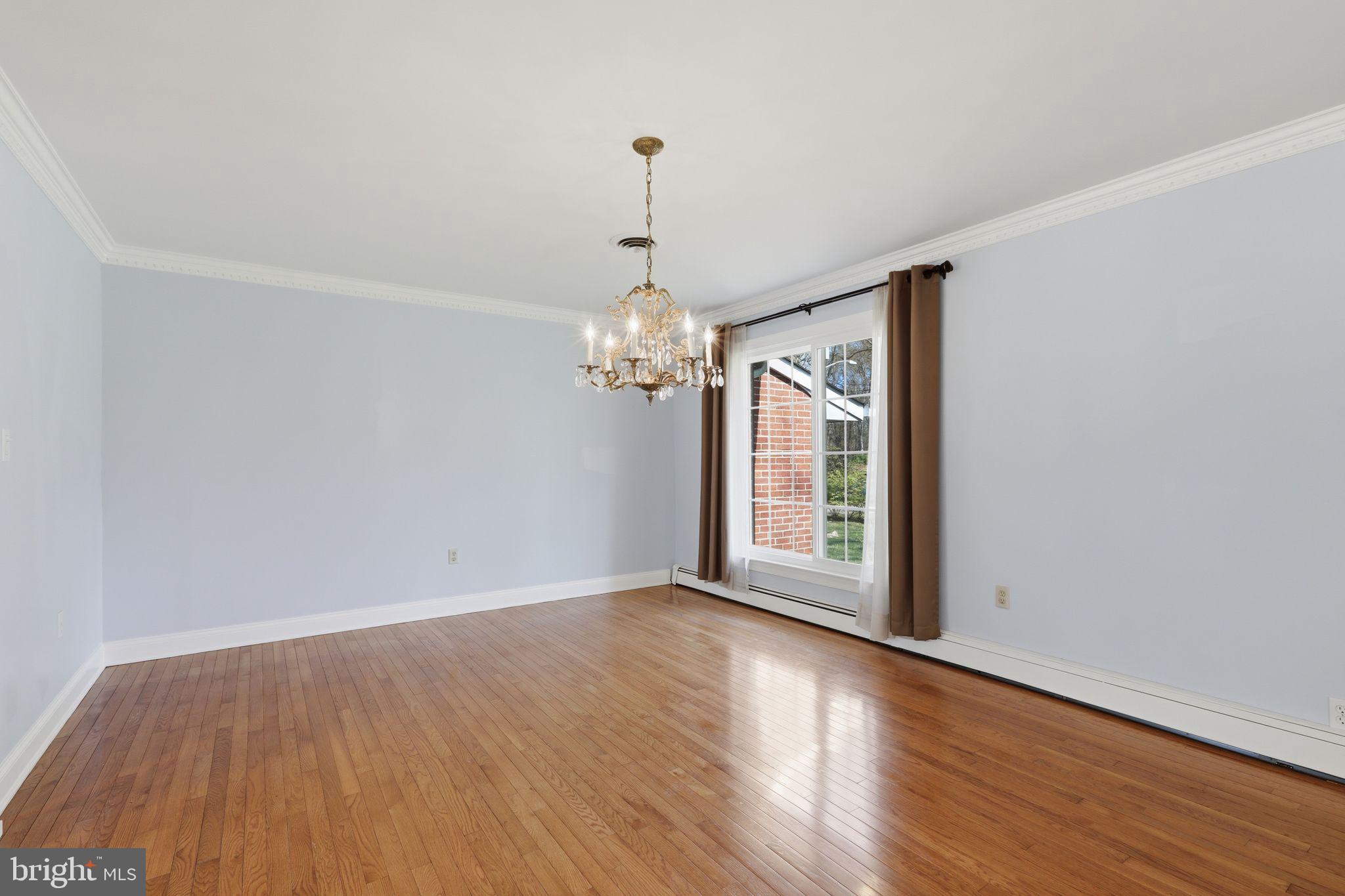35 Oriole Way Moorestown, NJ 08057 - Photo 7 of 45 an empty room with wooden floor chandelier and windows
