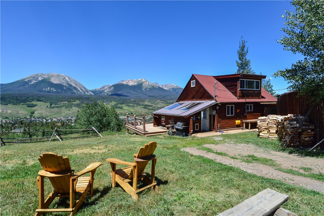 89 V Road Silverthorne, CO 80498 - Photo 2 of 25 Back side of the cabin. Awesome views of the Gore Range from all over this property.