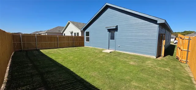 a view of house with backyard