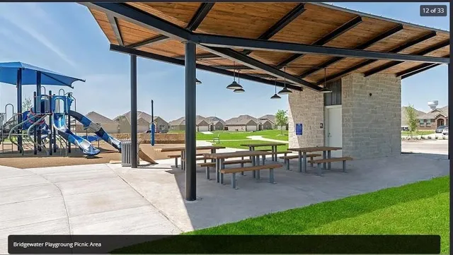 a view of a backyard with table and chairs