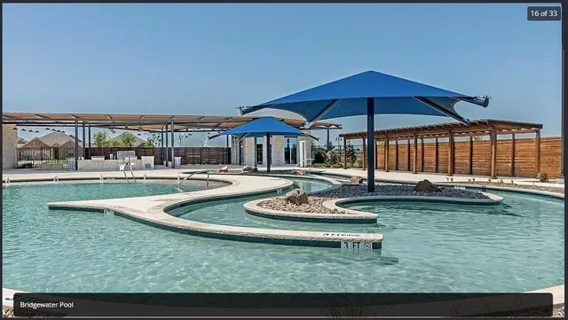 a swimming pool view with a seating space