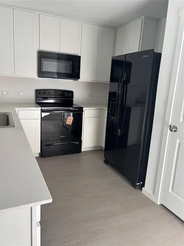 a kitchen with stainless steel appliances and wood cabinets