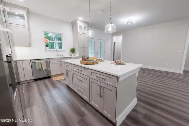 a view of a kitchen counter space with wooden floor and electronic appliances