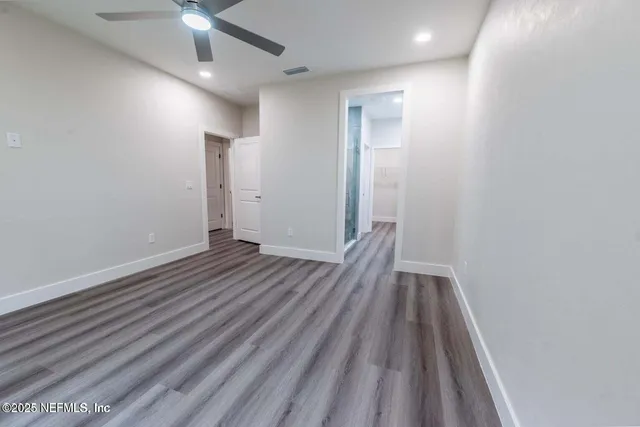 wooden floor in an empty room with a mirror