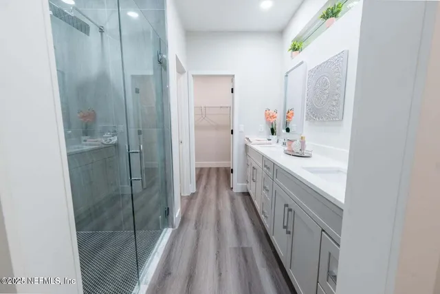 a bathroom with a double vanity sink and a mirror