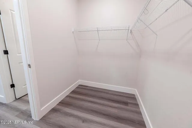 a spacious bathroom with a double vanity sink and a mirror