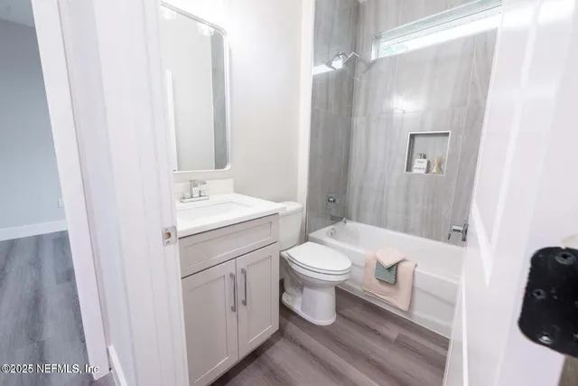 a bathroom with a toilet a sink and bathtub