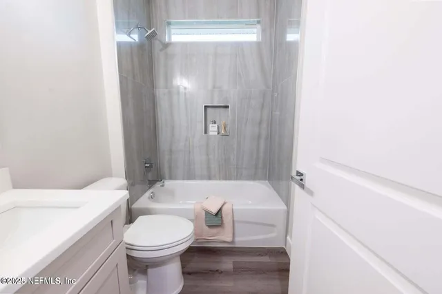wooden floor in an empty room with a window