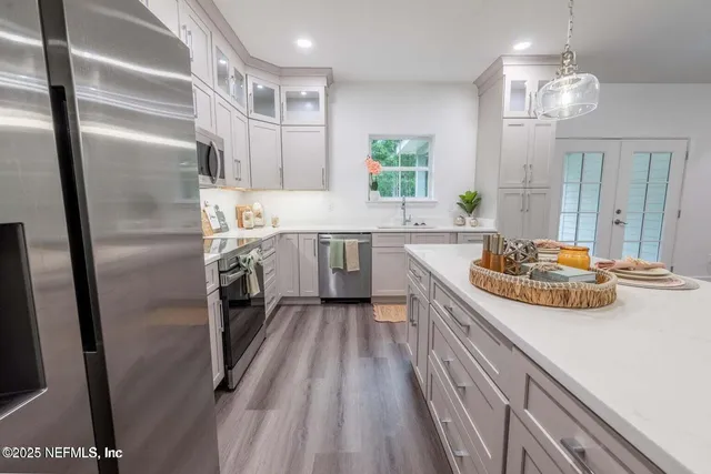 a kitchen with stainless steel appliances a sink stove and refrigerator