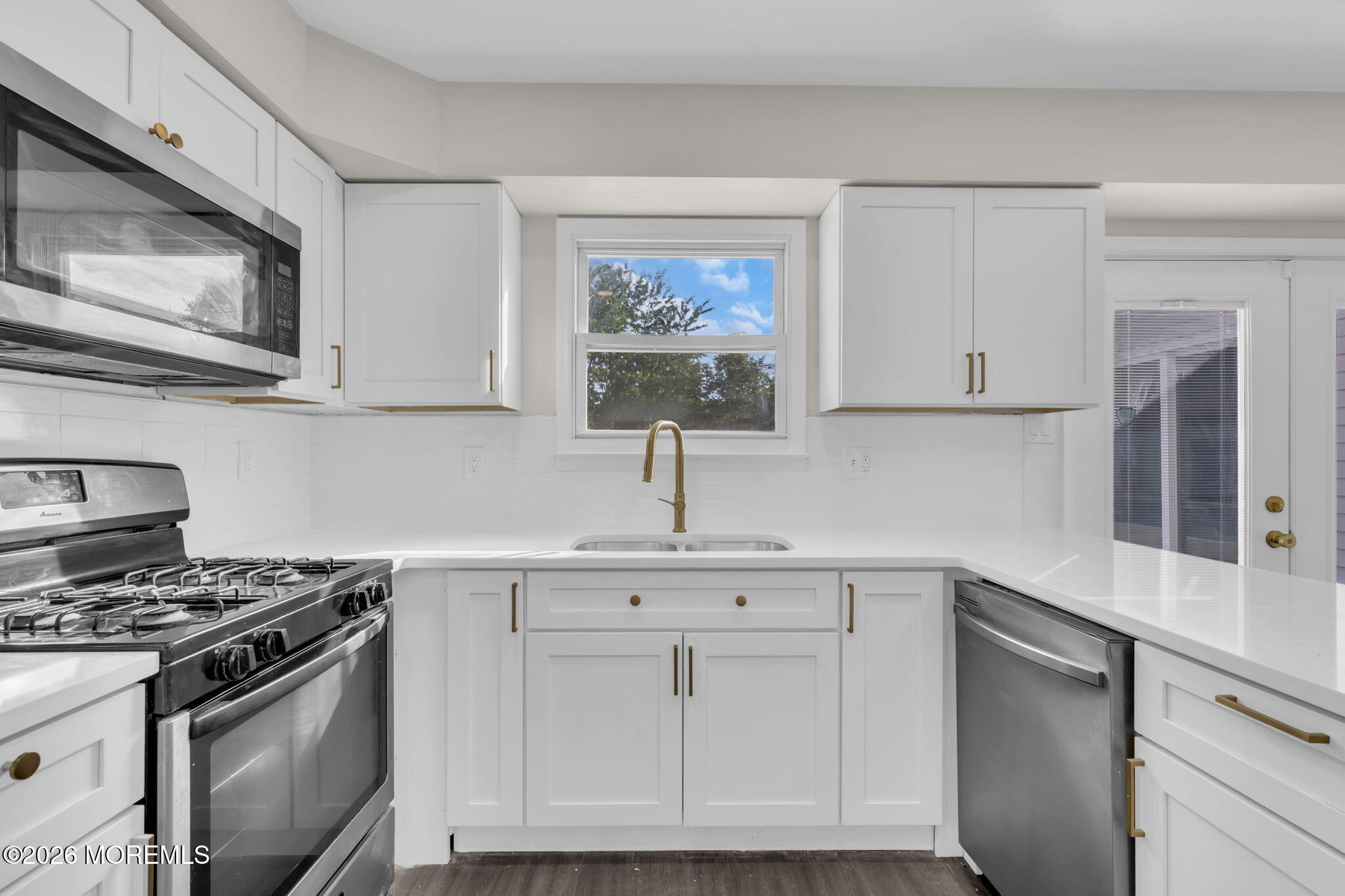 45 Peachstone Road Howell, NJ 07731 - Photo 28 of 54 a kitchen with white cabinets and appliances