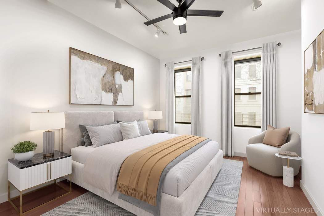 517 East 87th Street, Unit TRIPLEX Manhattan, NY 10128 - Photo 14 of 24 a bedroom with a bed and wooden floor