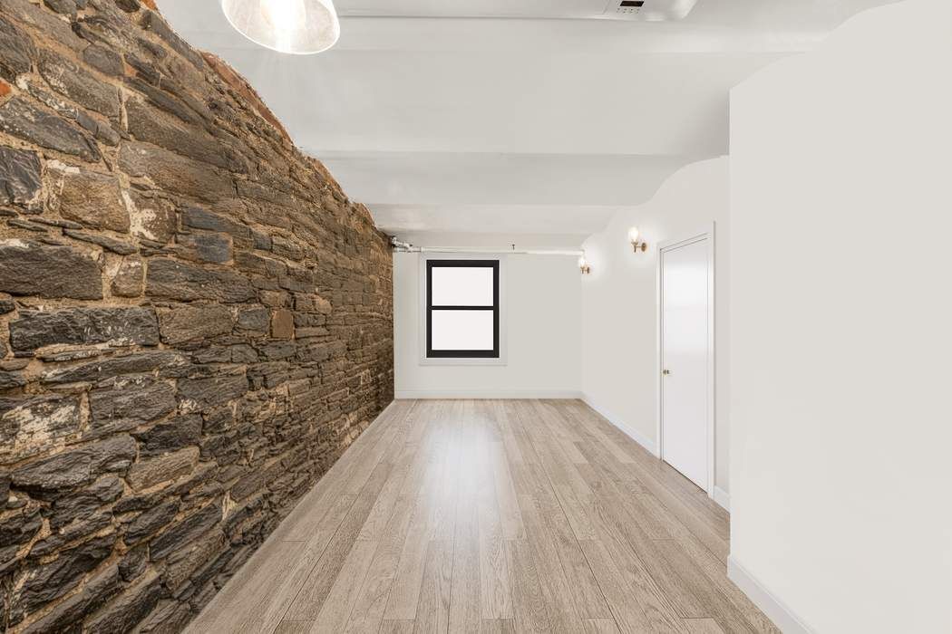 517 East 87th Street, Unit TRIPLEX Manhattan, NY 10128 - Photo 18 of 24 a view of a room with wooden floor and window