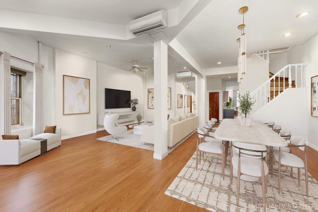 517 East 87th Street, Unit TRIPLEX Manhattan, NY 10128 - Photo 5 of 24 a living room with furniture and a flat screen tv