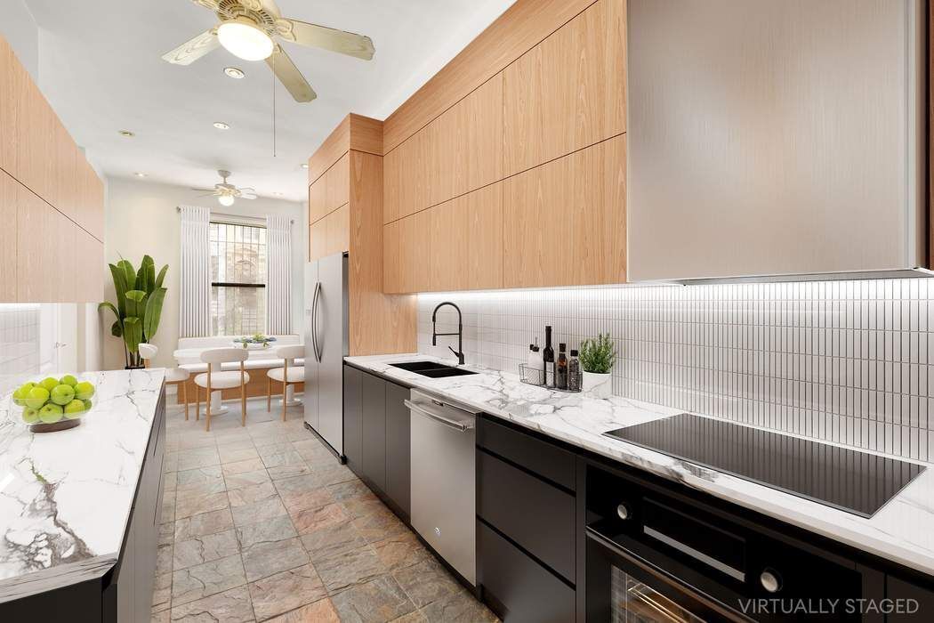 517 East 87th Street, Unit TRIPLEX Manhattan, NY 10128 - Photo 7 of 24 a kitchen with a sink appliances and cabinets