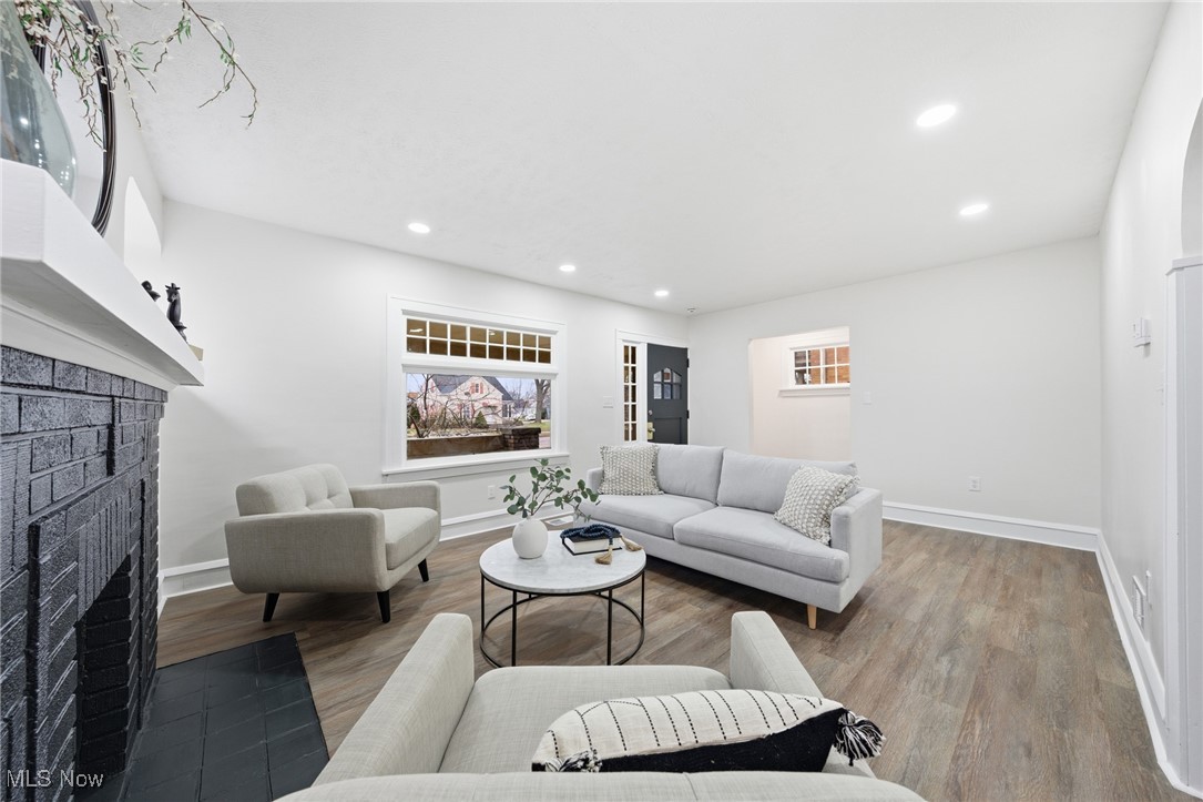 7911 Snow Road Parma, OH 44129 - Photo 5 of 44 Living room featuring a brick fireplace, wood finished floors, and recessed lighting