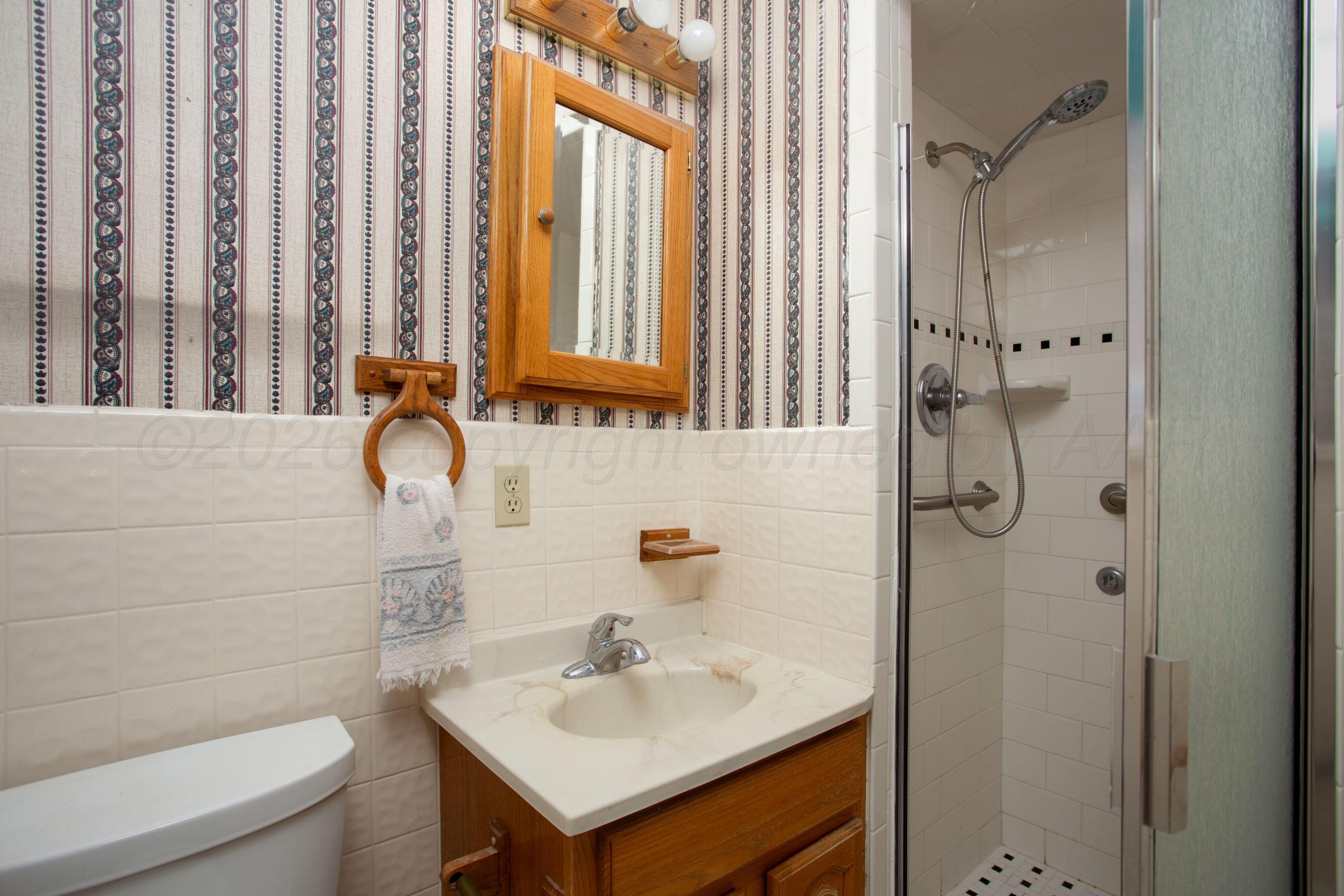 106 Renegade Trail Amarillo, TX 79108 - Photo 16 of 33 a bathroom with a sink a toilet and shower