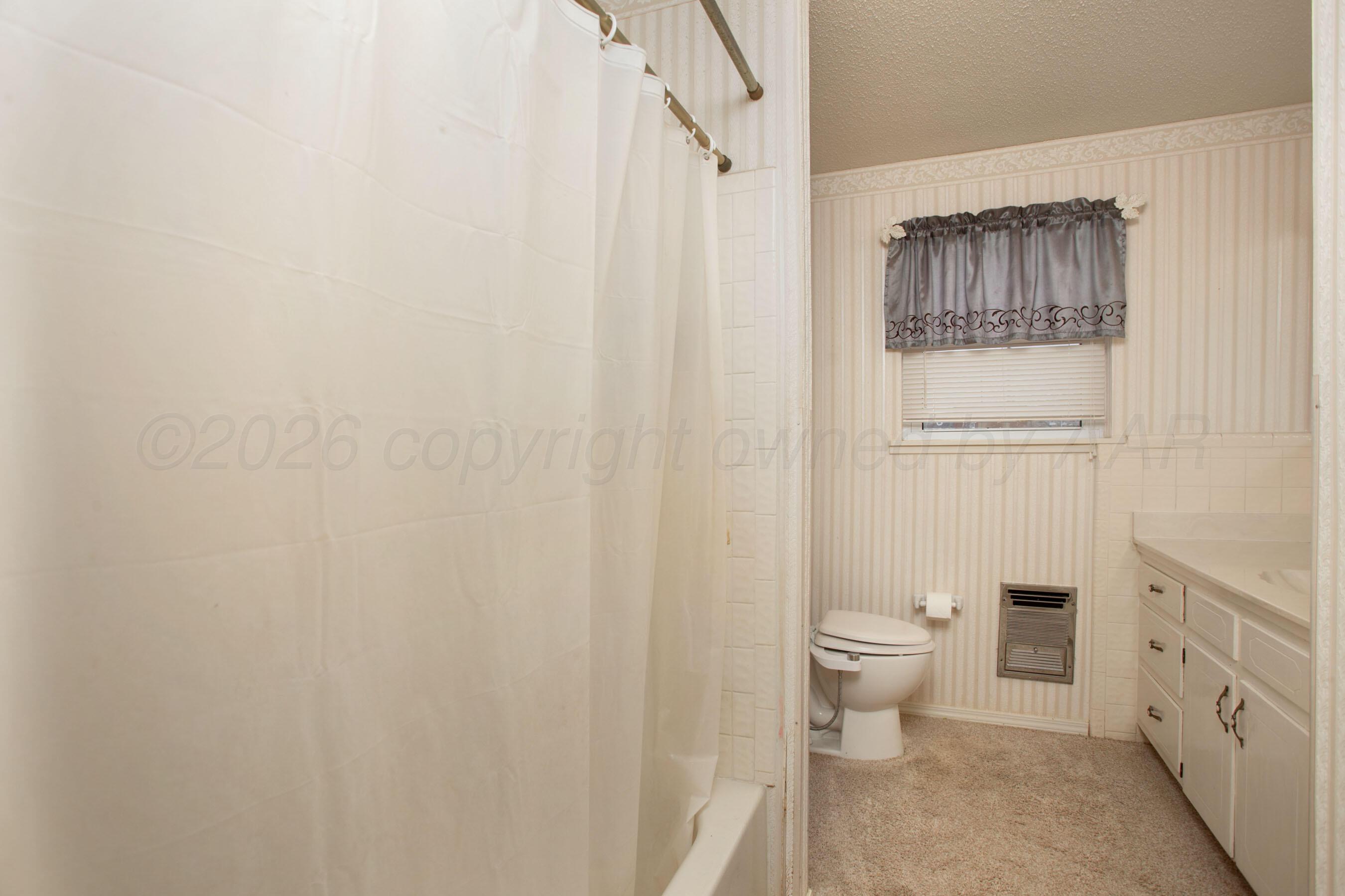 106 Renegade Trail Amarillo, TX 79108 - Photo 19 of 33 a bathroom with a toilet a sink and garden