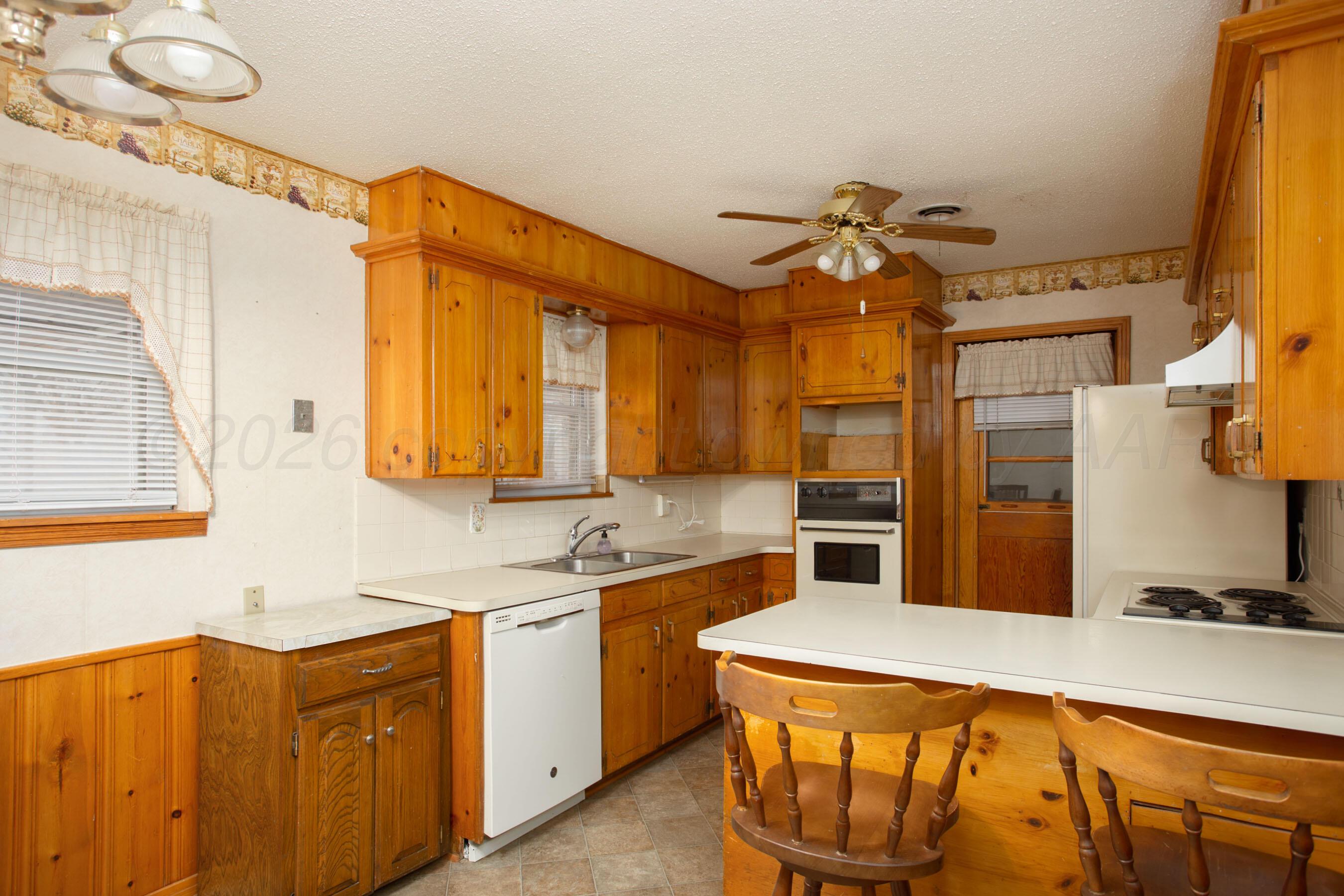 106 Renegade Trail Amarillo, TX 79108 - Photo 10 of 33 a kitchen with stainless steel appliances a sink cabinets and wooden floor