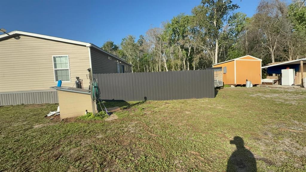 17151 Lemon Street Spring Hill, FL 34610 - Photo 11 of 18 a backyard of a house with a yard and seating space