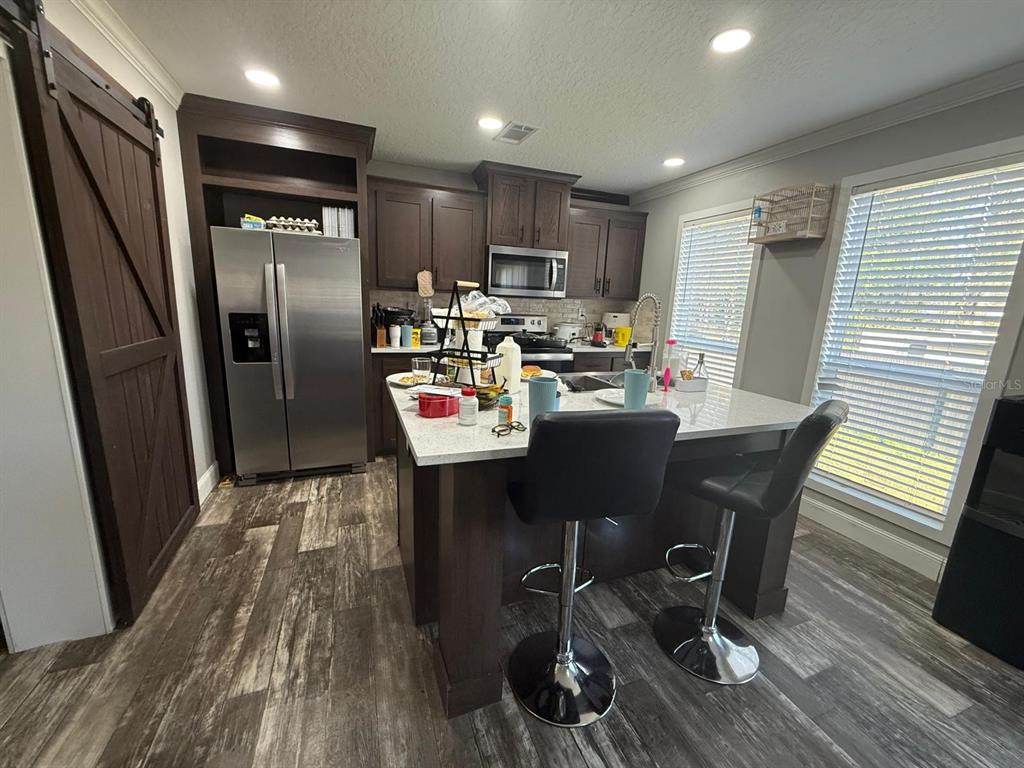 17151 Lemon Street Spring Hill, FL 34610 - Photo 13 of 18 a view of a dining room with furniture a rug and wooden floor