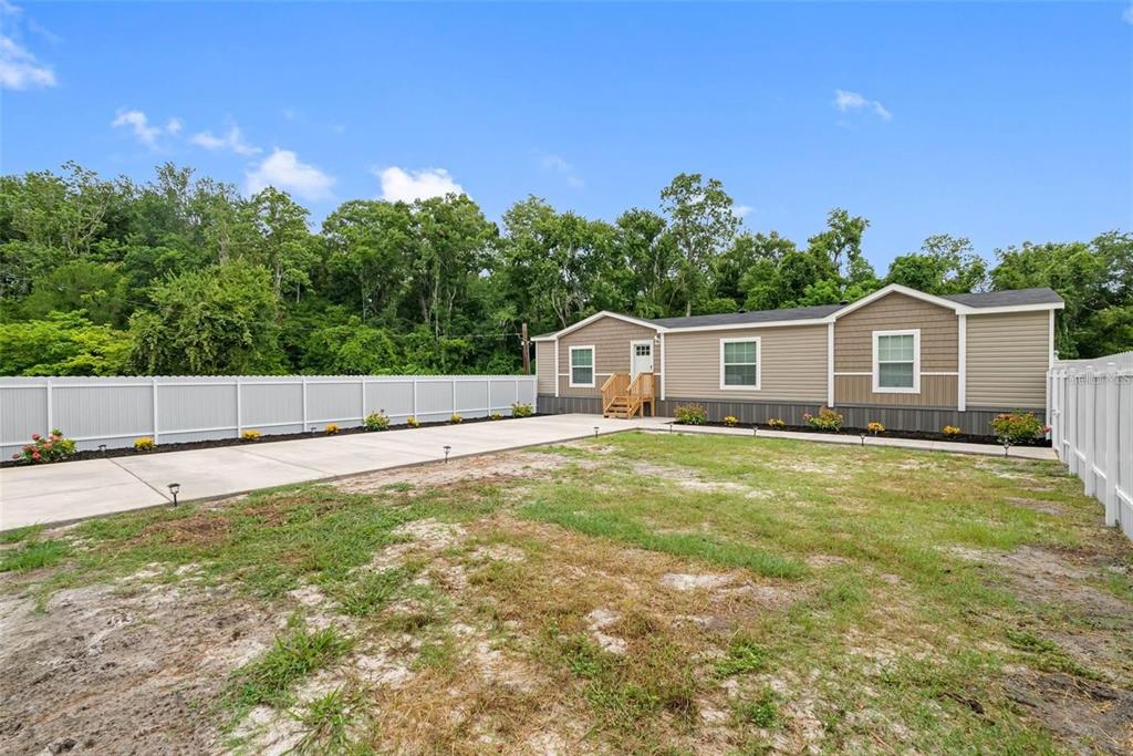 17151 Lemon Street Spring Hill, FL 34610 - Photo 3 of 18 a view of a house with backyard and trees