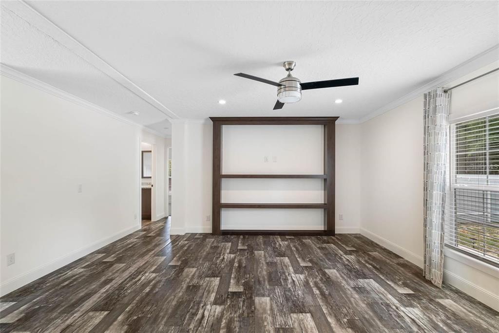 17151 Lemon Street Spring Hill, FL 34610 - Photo 8 of 18 a view of empty room with wooden floor and fan
