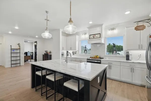 a kitchen with a table and chairs in it