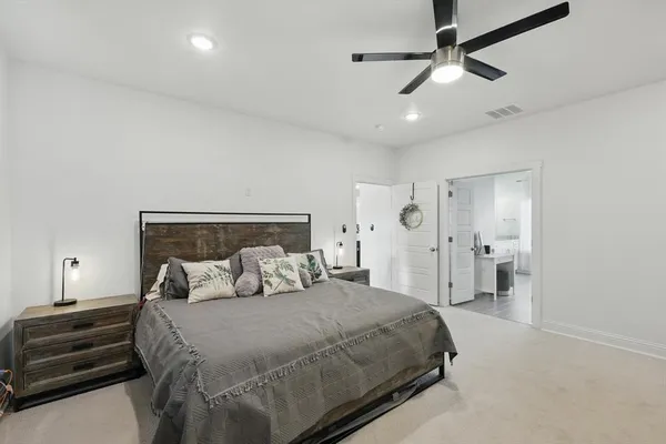 a bedroom with a bed and ceiling fan