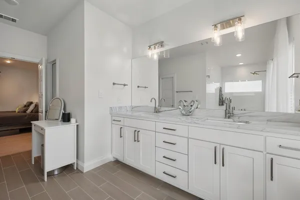 a bathroom with a sink double vanity and a mirror