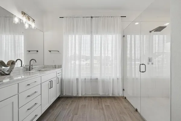a bathroom with a double vanity sink and mirror