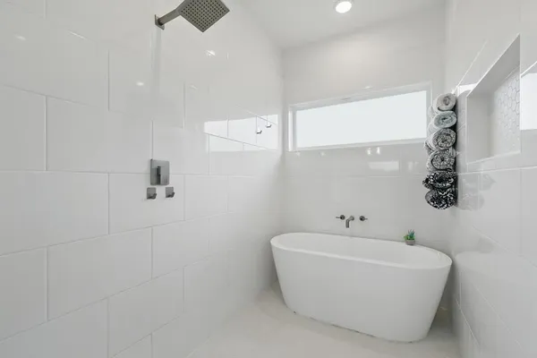 a bathroom with a bathtub and shower
