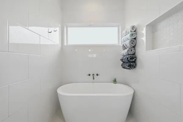 a white bath tub sitting in a bathroom