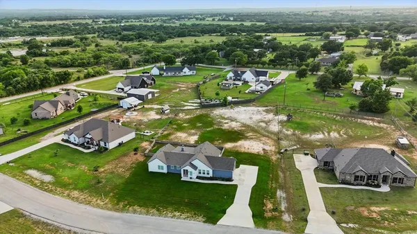 an aerial view of a houses with a yard