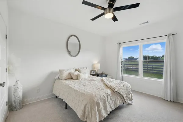 a bedroom with bed and window