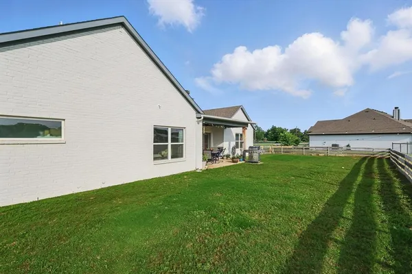 a front view of house with yard and green space