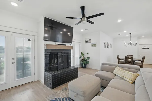 a living room with furniture a flat screen tv and a fireplace
