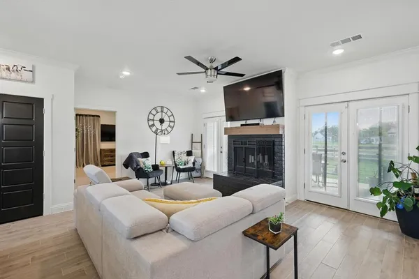 a living room with furniture a fireplace and a flat screen tv