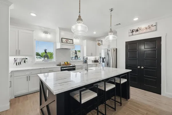 a kitchen with a table and chairs in it