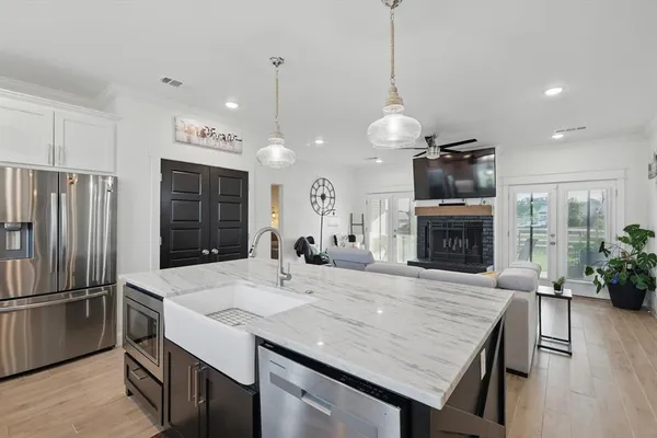a kitchen with sink refrigerator and microwave
