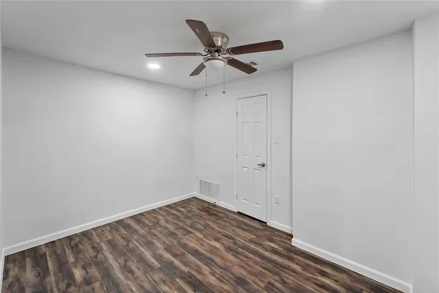 a view of a hallway with a ceiling fan