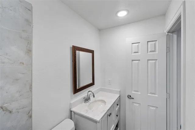 a bathroom with a sink vanity and mirror